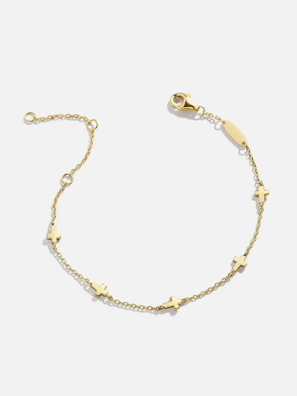 Delicate gold chain bracelet with small cross charms and a lobster clasp on white background