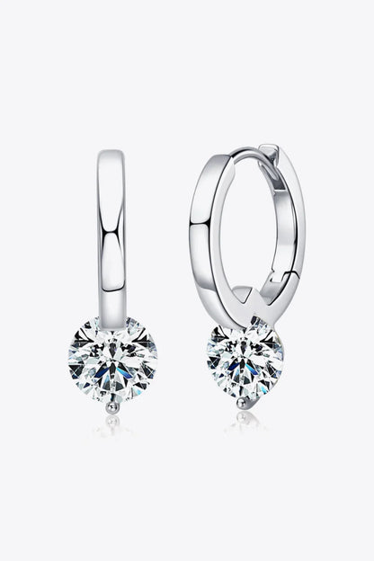 Silver hoop earrings with round clear gemstone drops on white background