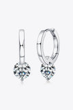 Silver hoop earrings with round clear gemstone drops on white background