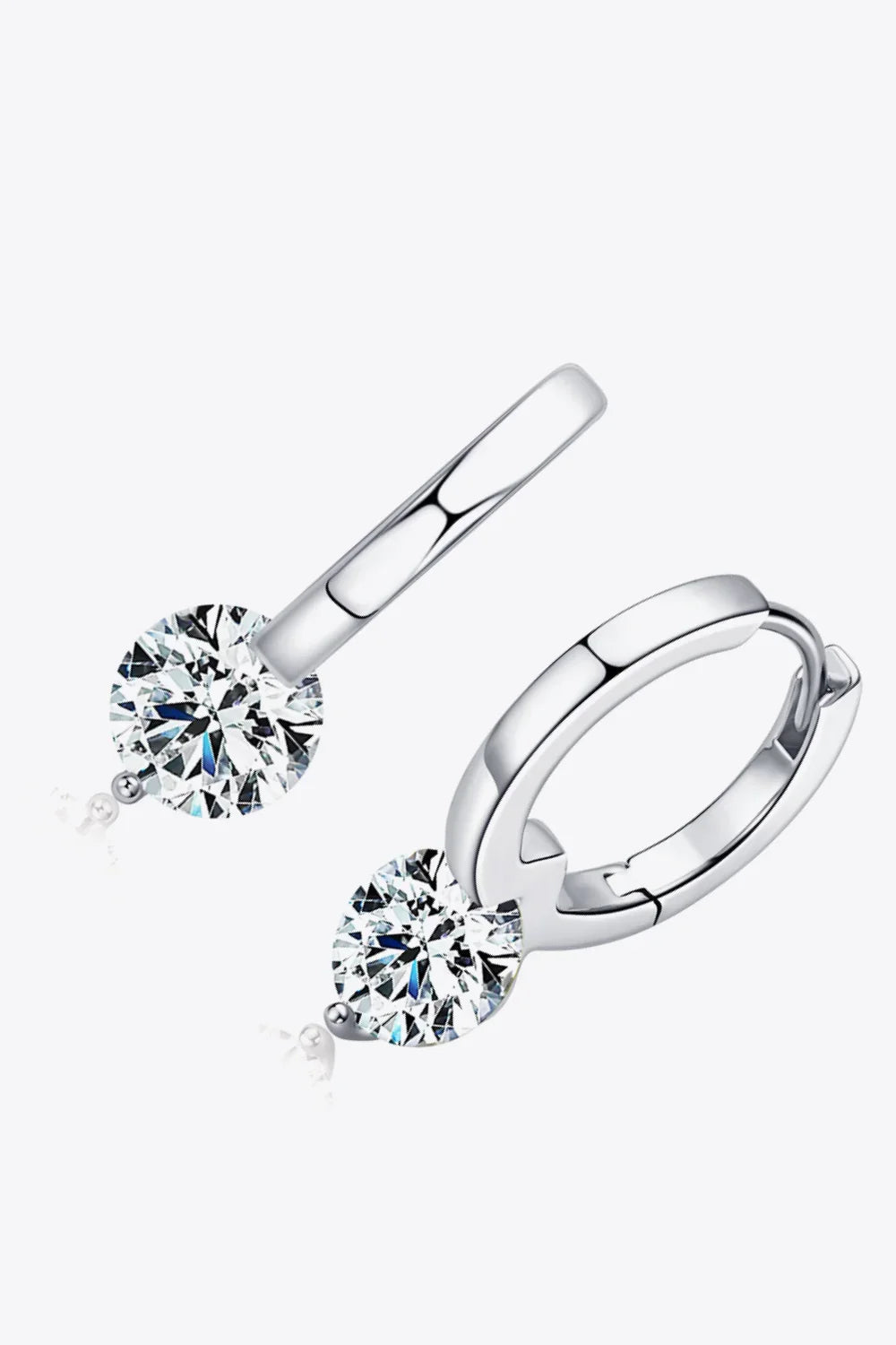 Silver hoop earrings with round clear crystal dangles on a white background