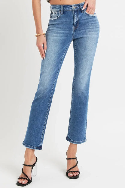 Woman wearing high-waisted straight leg blue jeans and black heeled sandals