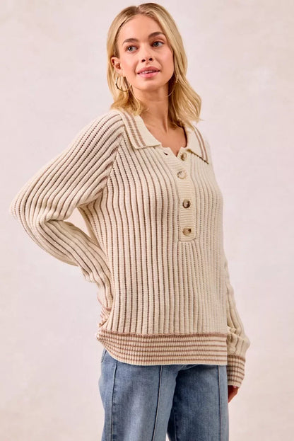 Woman wearing a cream ribbed knit sweater with button collar and light blue jeans