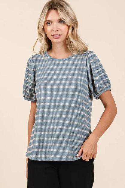 Woman wearing a blue striped short-sleeve blouse with relaxed fit and puffed sleeves