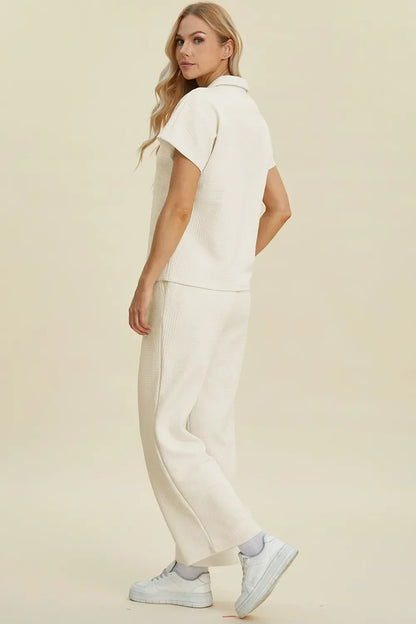 Woman wearing an off-white textured lounge set with short sleeves and relaxed pants
