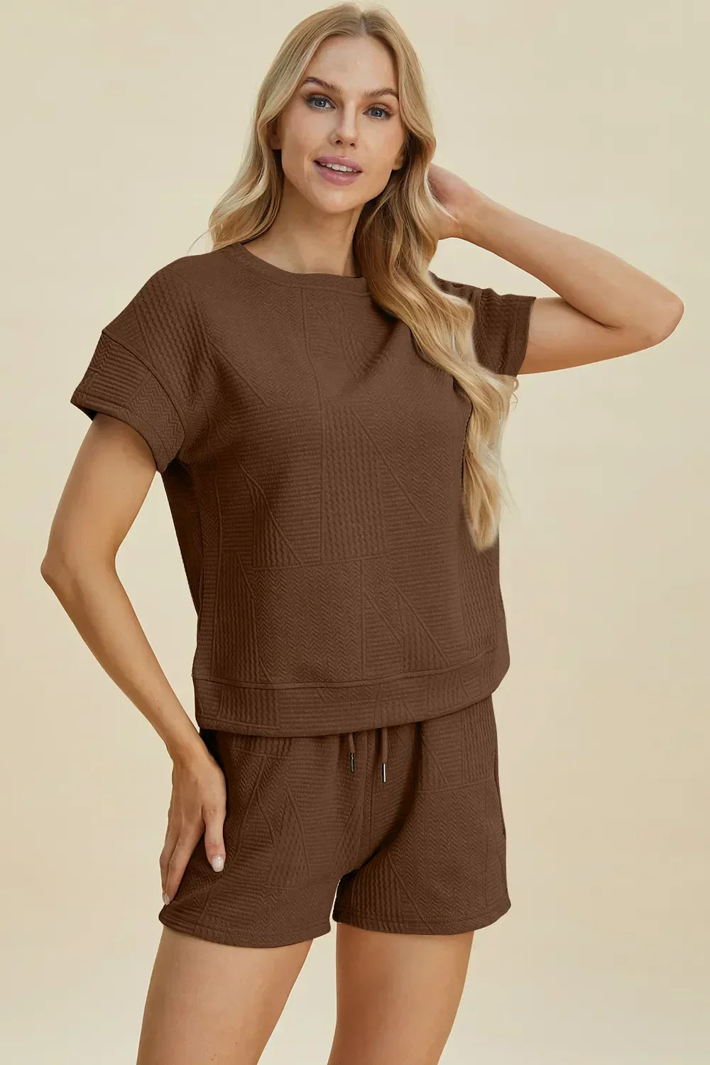 Woman wearing a brown textured short sleeve lounge set with relaxed fit shorts