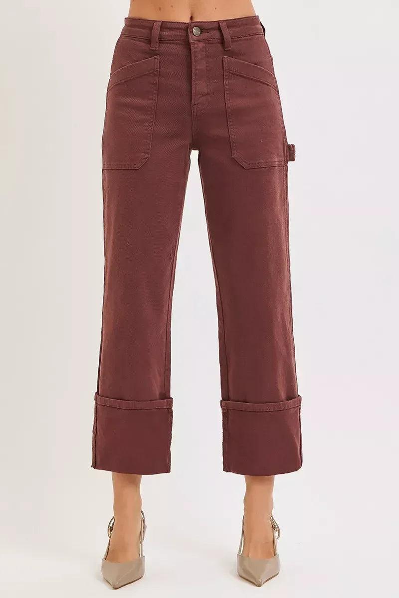 Women's high-waisted brown wide-leg pants with large front pockets and cuffed hem