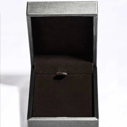 Empty elegant black velvet jewelry box with open lid on a white background