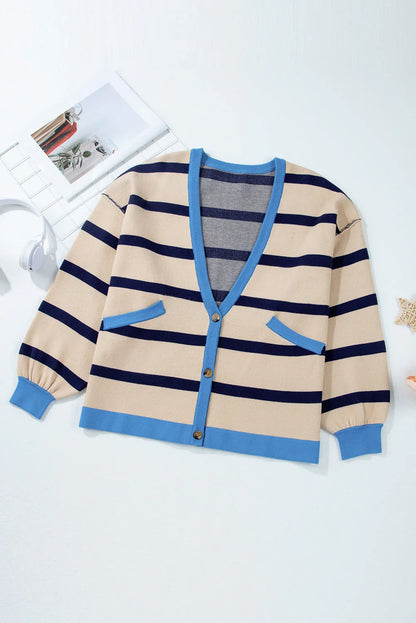 Beige and navy blue striped cardigan with blue trim and front pockets on a white background.
