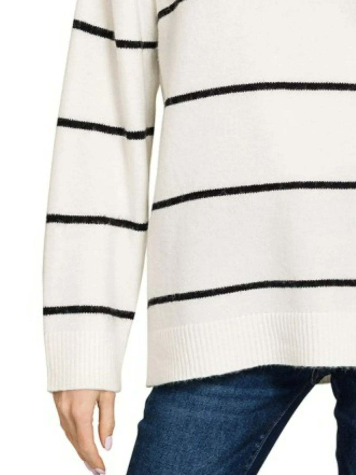 White sweater with black horizontal stripes paired with blue jeans