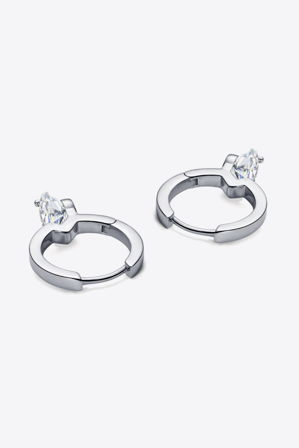 Pair of silver hoop earrings with marquise-cut clear gemstones on a white background