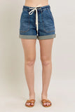 High-waisted denim shorts with rolled hems, front pockets, and white drawstring, modeled.