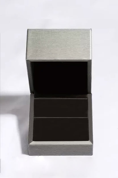 Open empty jewelry box with a sleek metallic finish on a white background