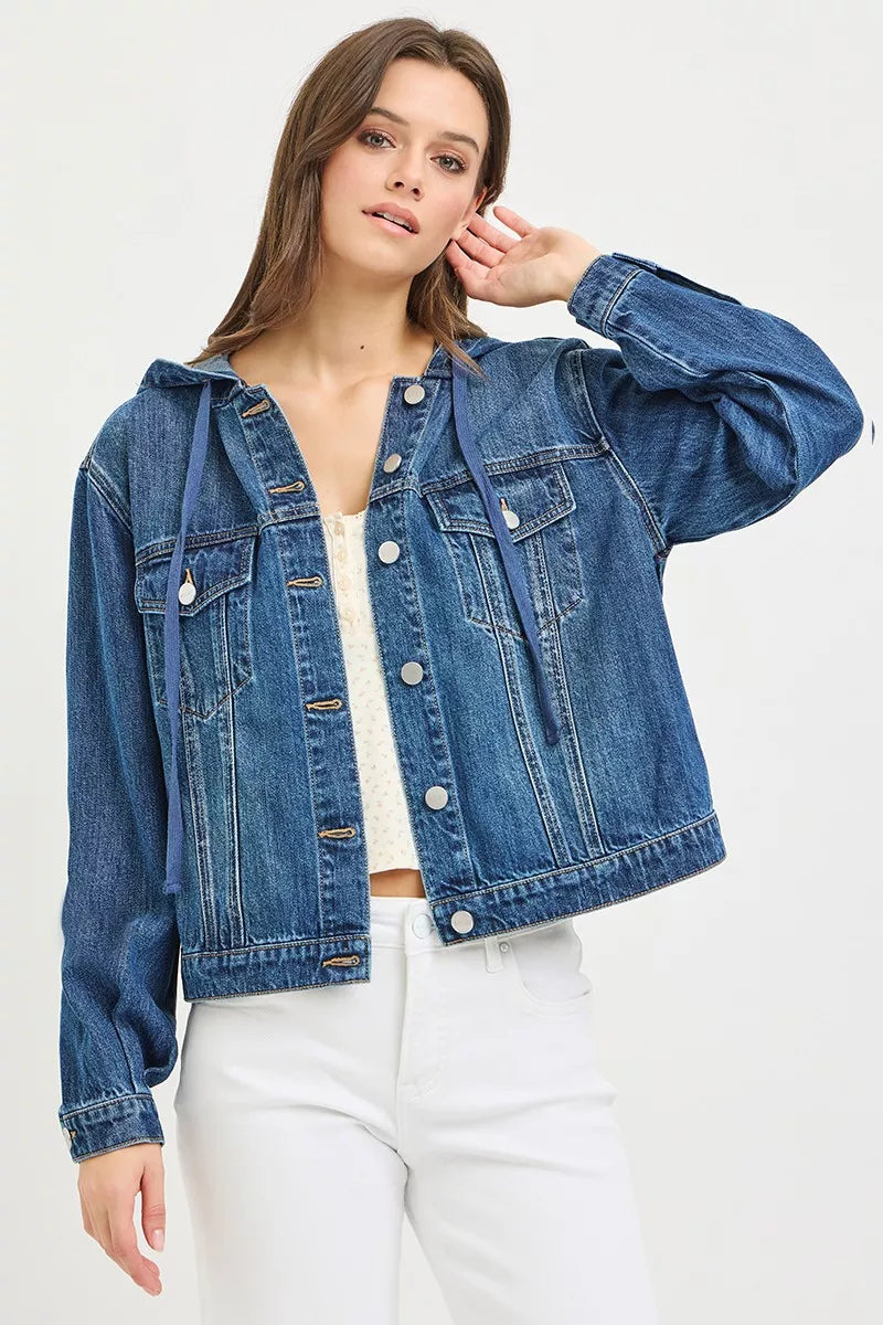 woman wearing a button-up Denim Jacket with Hoodie, white tank top and white jeans on a white background