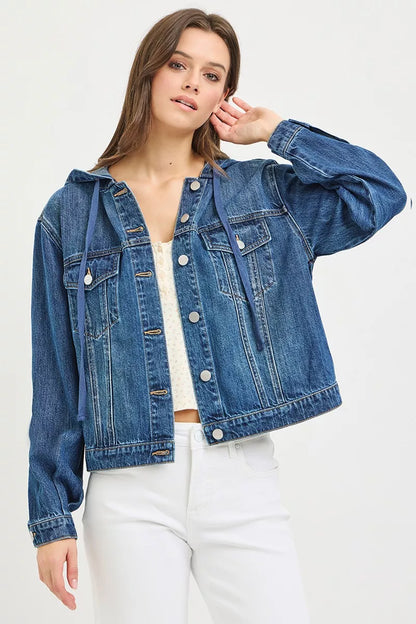 woman wearing a button-up Denim Jacket with Hoodie, white tank top and white jeans on a white background