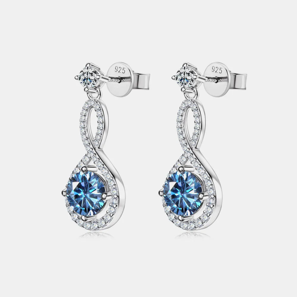 Sterling silver drop earrings with blue center stones and crystal accents on white background
