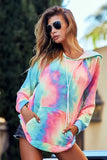 Woman wearing a relaxed tie-dye hoodie with front pocket and drawstrings outdoors