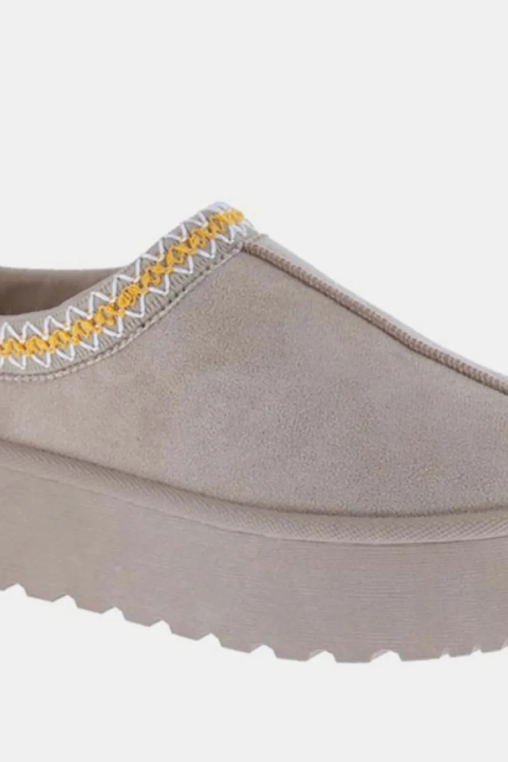 Taupe suede slip-on platform shoe with yellow and white stitched detailing