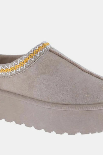 Taupe suede slip-on platform shoe with yellow and white stitched detailing