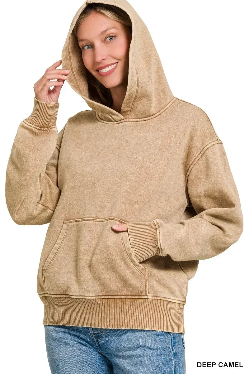 Woman wearing a deep camel hooded sweatshirt with relaxed fit and front pocket, casual style