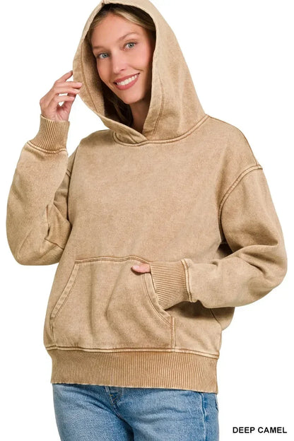 Woman wearing a deep camel hooded sweatshirt with relaxed fit and front pocket, casual style