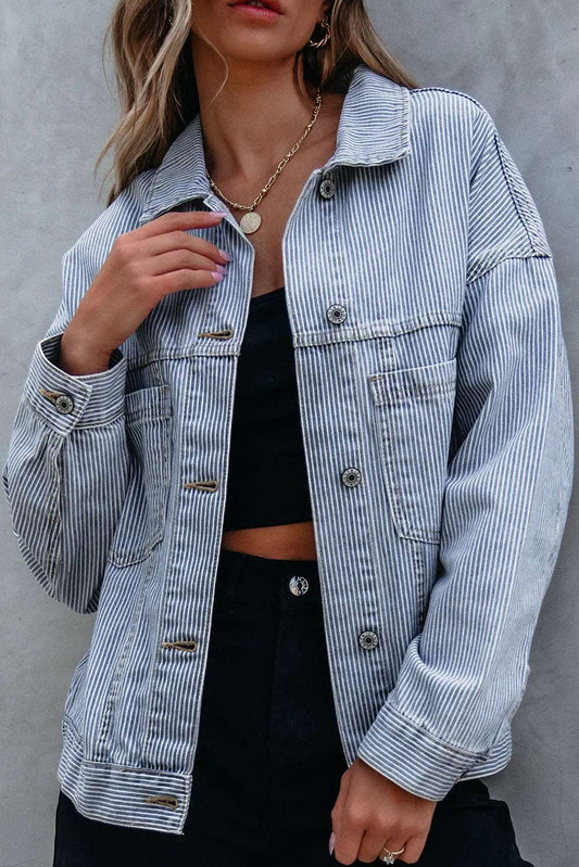 Woman wearing a relaxed fit blue and white pinstripe denim jacket with black top and pants