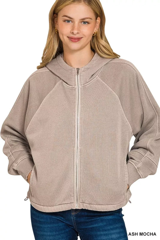 Woman wearing ash mocha zip-up hoodie with relaxed fit and casual denim jeans