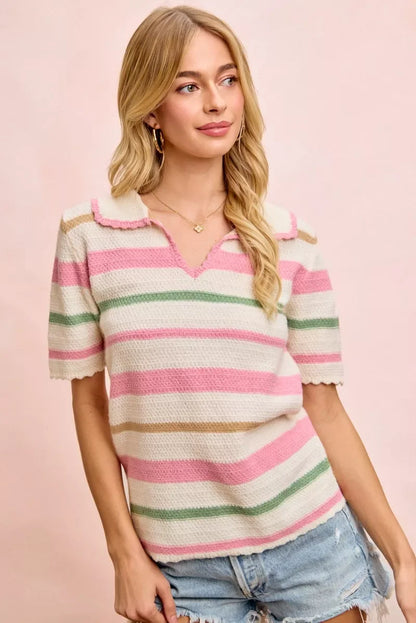 Woman wearing a short-sleeve pink, green, and beige striped knit top with denim shorts