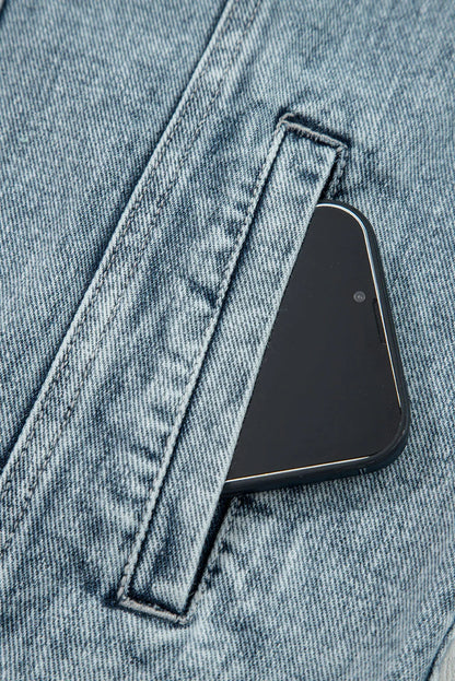 Smartphone in light wash denim pocket, close-up of durable jeans fabric