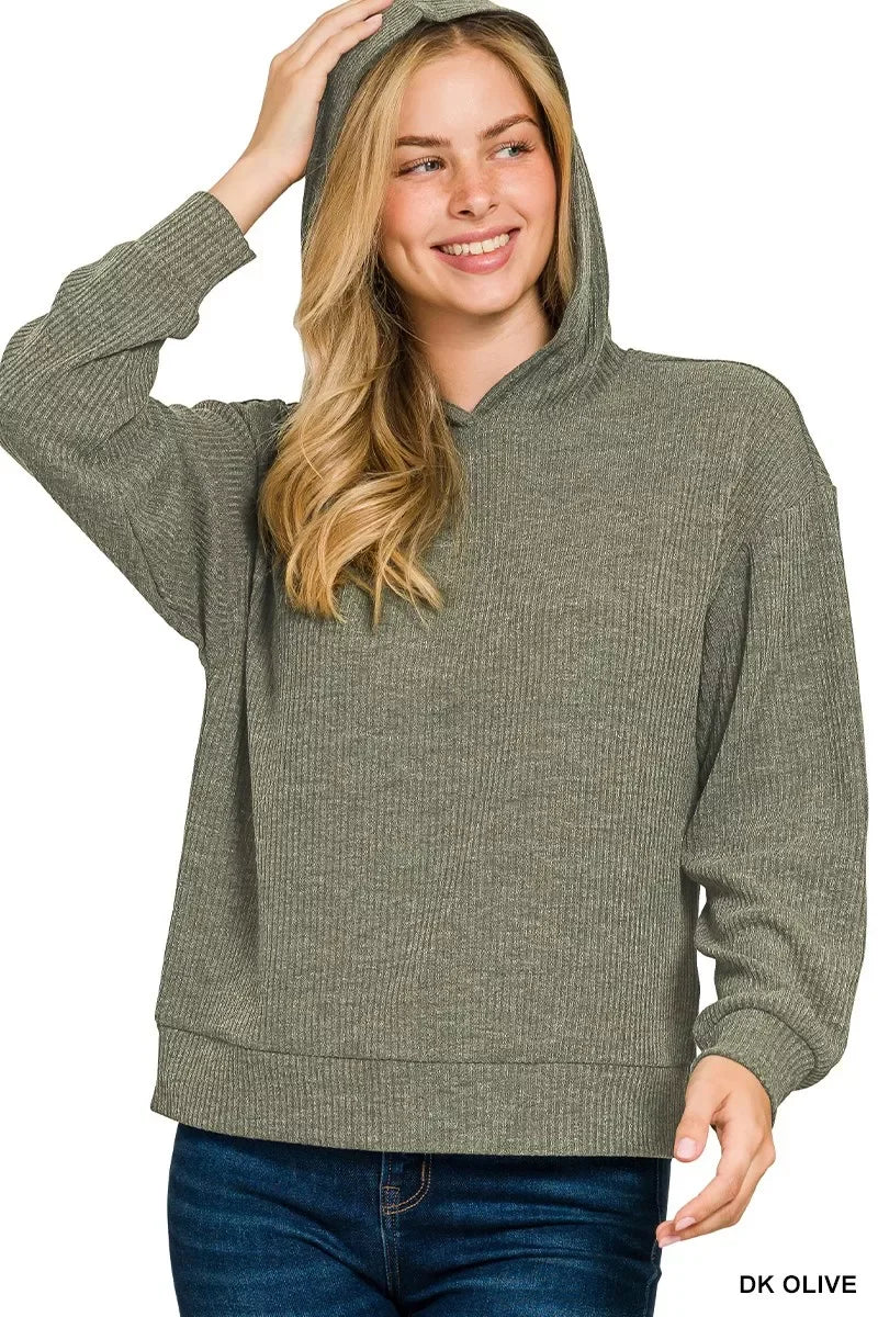 Woman wearing a dark olive ribbed knit hooded sweater with relaxed fit and long sleeves