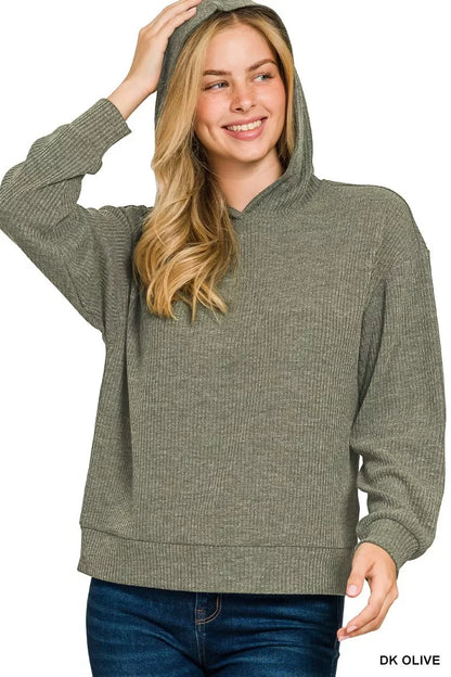 Woman wearing a dark olive ribbed knit hooded sweater with relaxed fit and long sleeves
