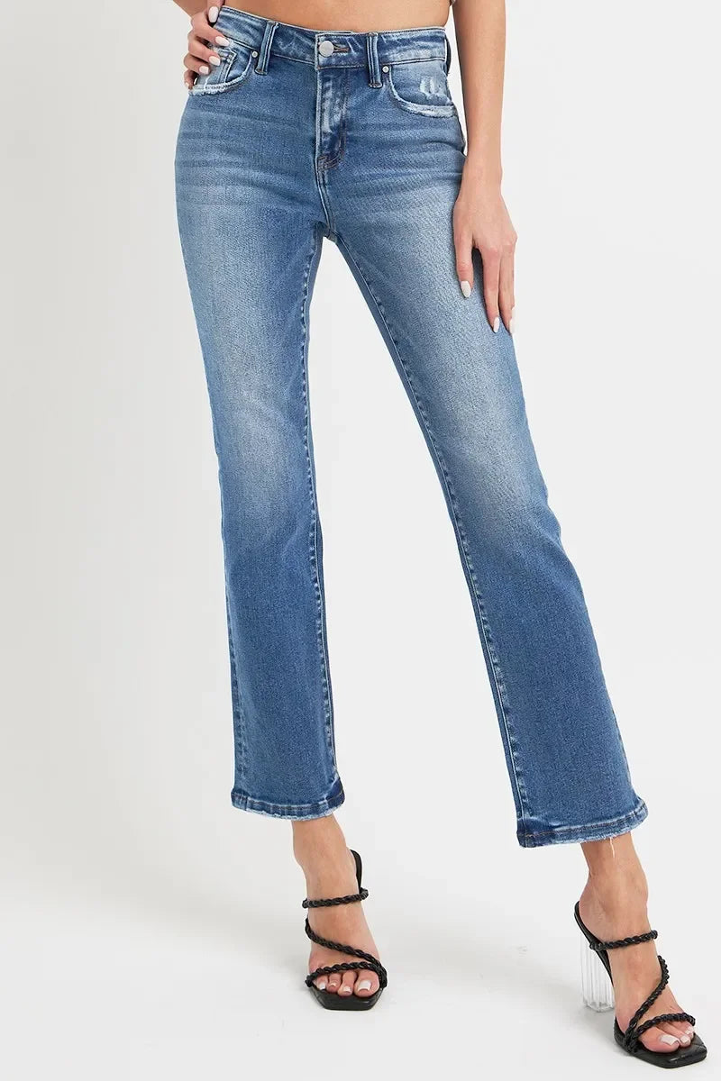 Woman wearing high-waisted straight leg blue jeans with black heeled sandals