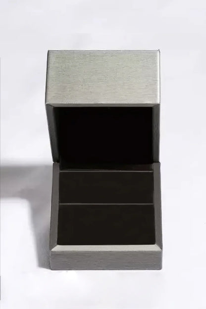 Open gray jewelry box with velvet interior on white background