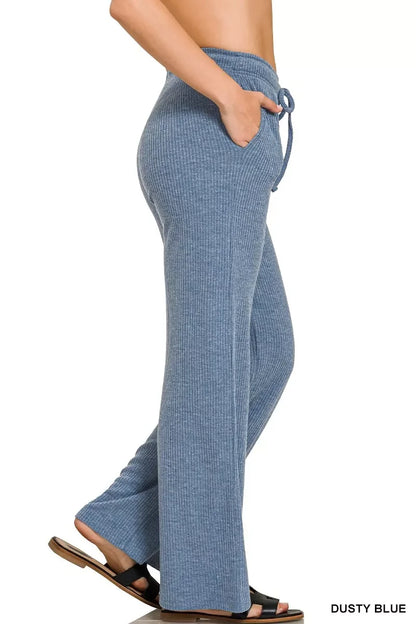 Woman wearing relaxed fit, ribbed knit lounge pants in dusty blue with drawstring waist