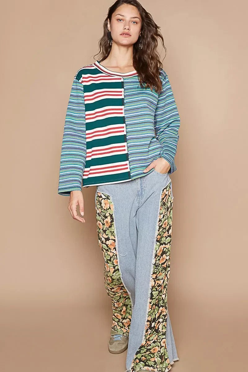 Woman wearing a striped long-sleeve top and wide-leg pants with floral panels