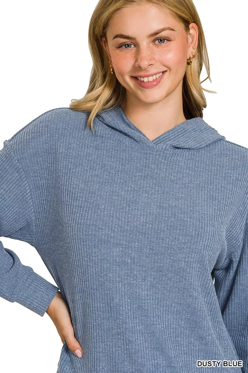 Woman wearing a ribbed dusty blue hoodie with relaxed, casual fit on white background.