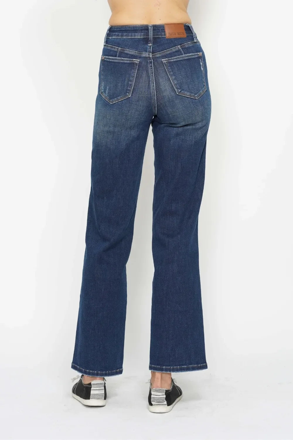 Back view of high-rise straight leg blue jeans with wide pockets on a white background