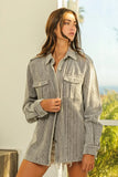 Woman wearing relaxed fit grey corduroy shirt jacket with chest pockets and frayed hem