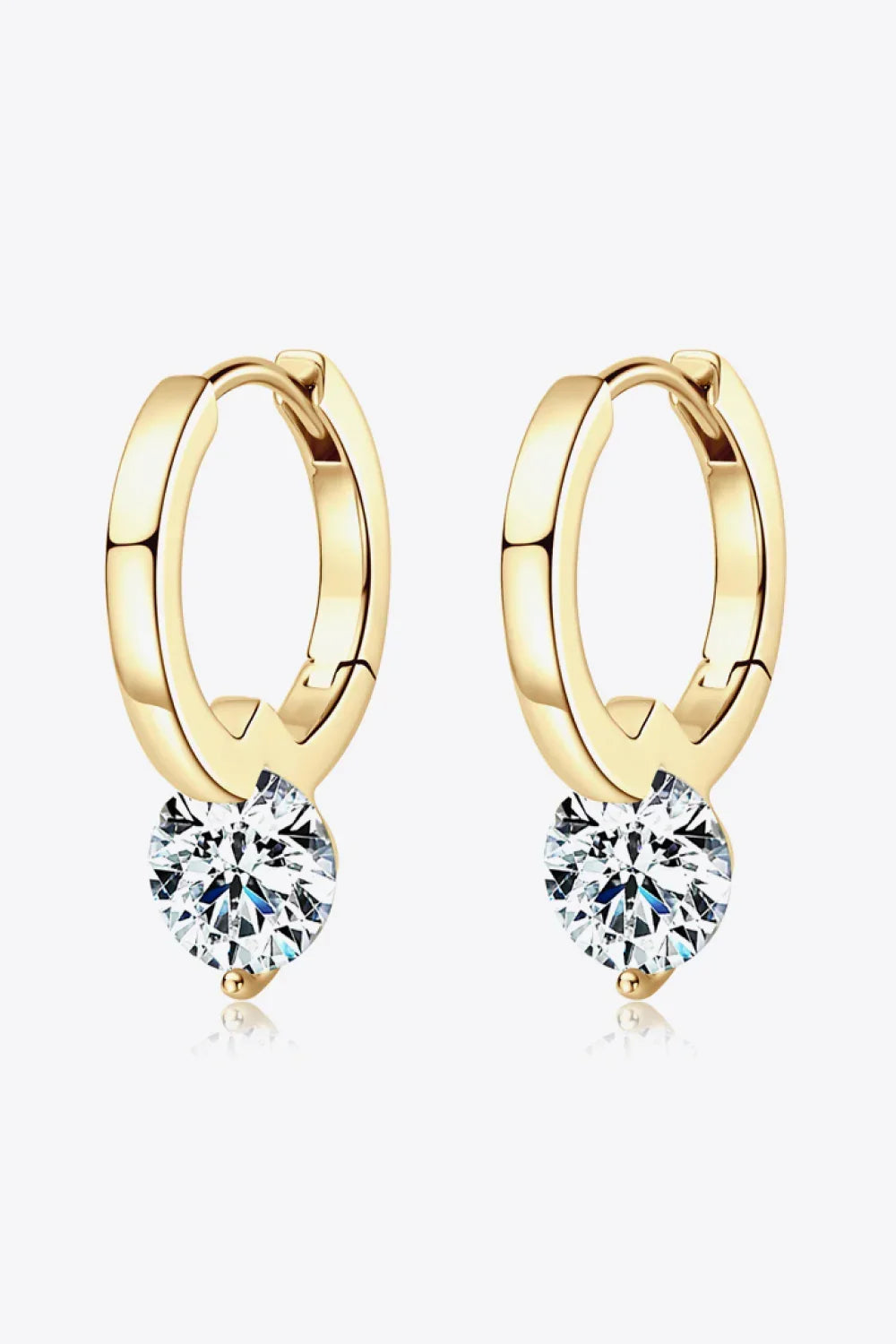 Gold hoop earrings with round clear gemstone dangles on white background