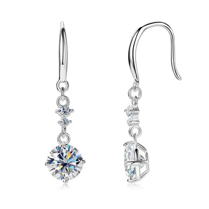 Silver drop earrings with sparkling round and small cubic zirconia stones on white background