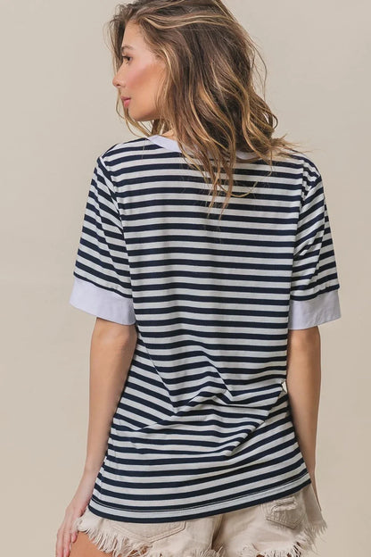 Woman wearing a BiBi Contrast Striped Notched Knit Top and frayed hem shorts, viewed from behind.