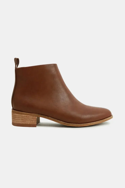 Women's brown leather ankle boot with low stacked heel on a white background