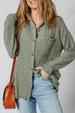 Woman wearing a ribbed sage green button-up shirt with jeans and a brown shoulder bag