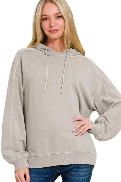 Woman wearing an ash mocha oversized hoodie with relaxed fit and blue jeans