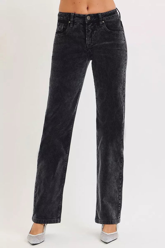 Woman wearing high-waisted black corduroy straight-leg pants with silver heels