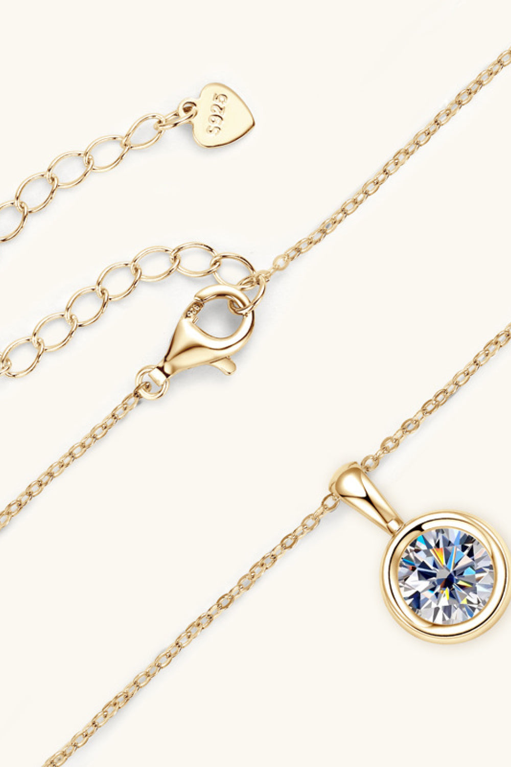 Gold chain necklace with clear round gemstone pendant and adjustable clasp detail