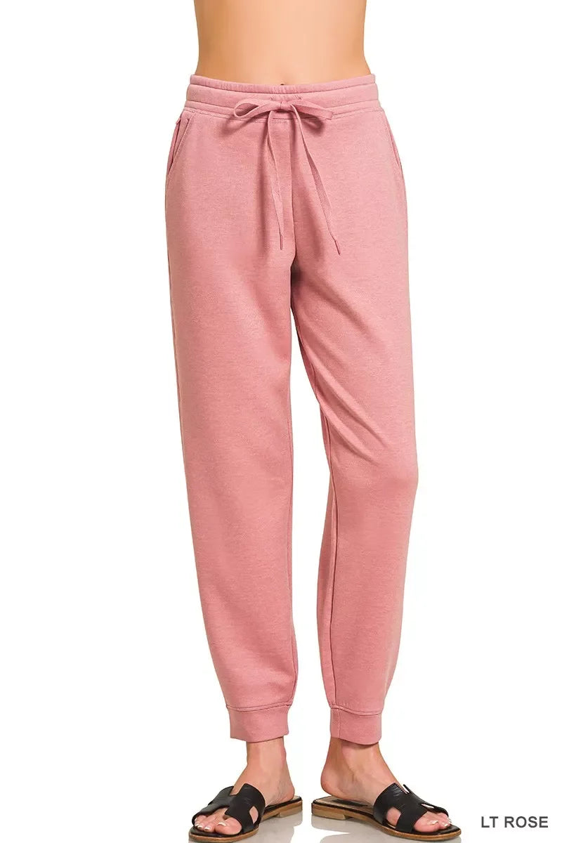 Light rose pink women's jogger pants with elastic cuffs and drawstring waist