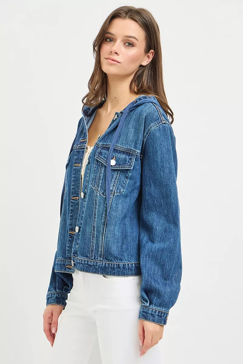 Side view  of a woman wearing a button-up Denim Jacket with Hoodie, white tank top and white jeans on a white background