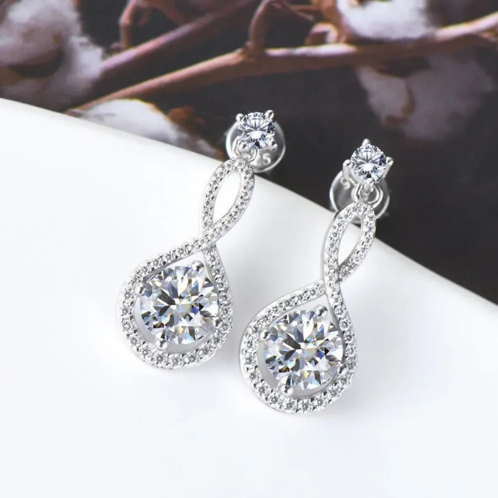 Elegant silver drop earrings with sparkling cubic zirconia stones on a white surface
