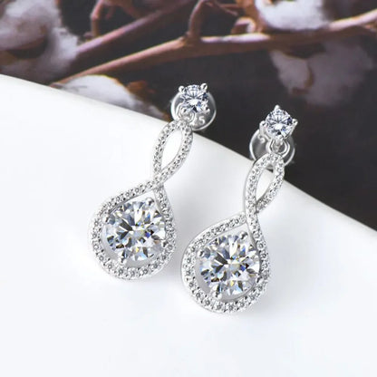Elegant silver drop earrings with sparkling cubic zirconia stones on a white surface
