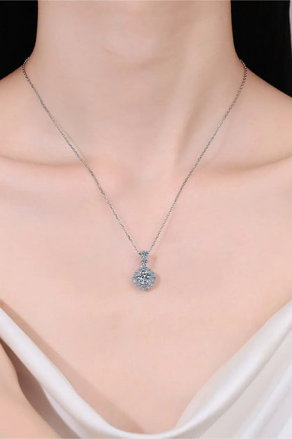 Silver chain necklace with sparkling crystal pendant on model wearing off-shoulder top